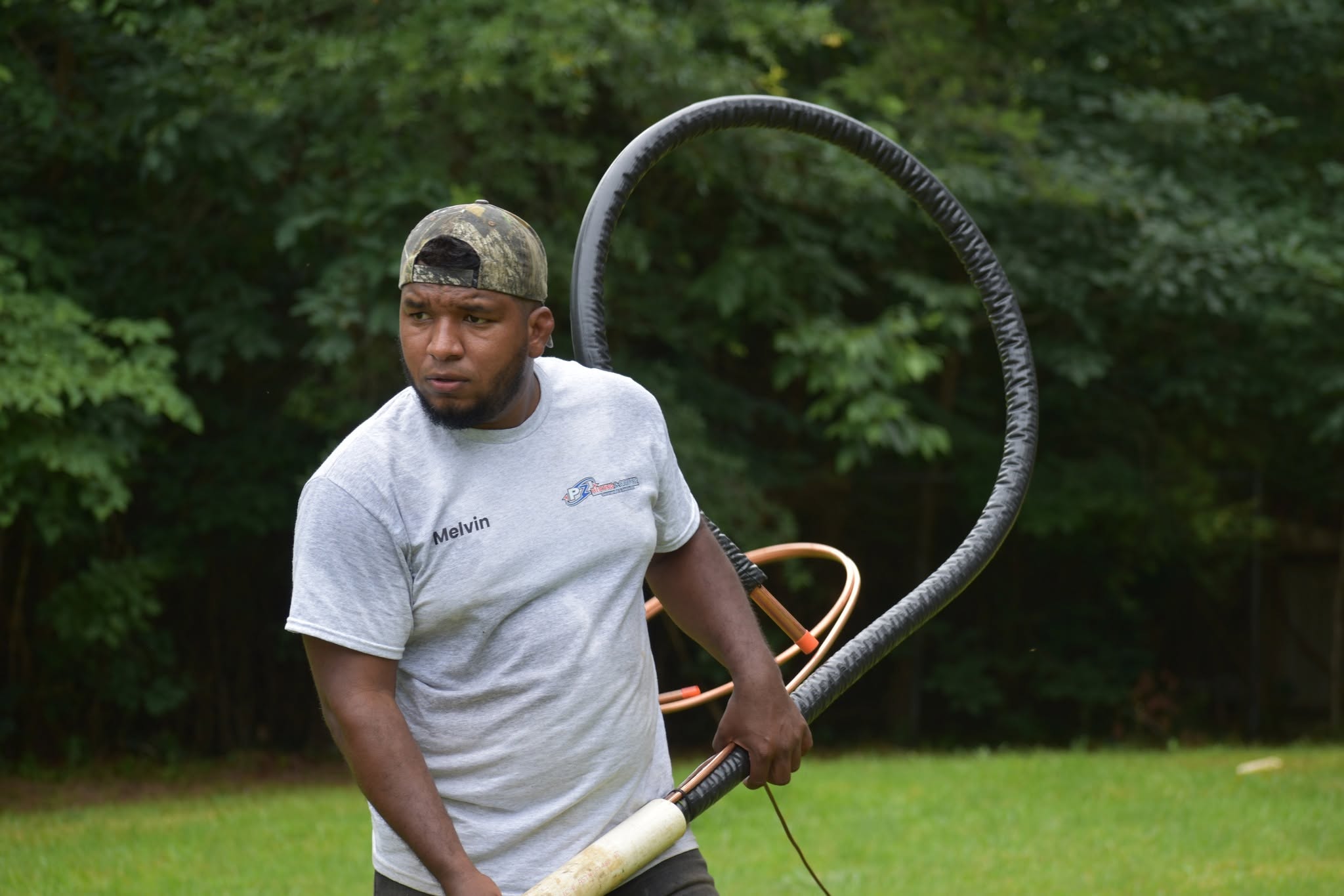 PZ Heating & Cooling technician Melvin carrying refrigerant line set